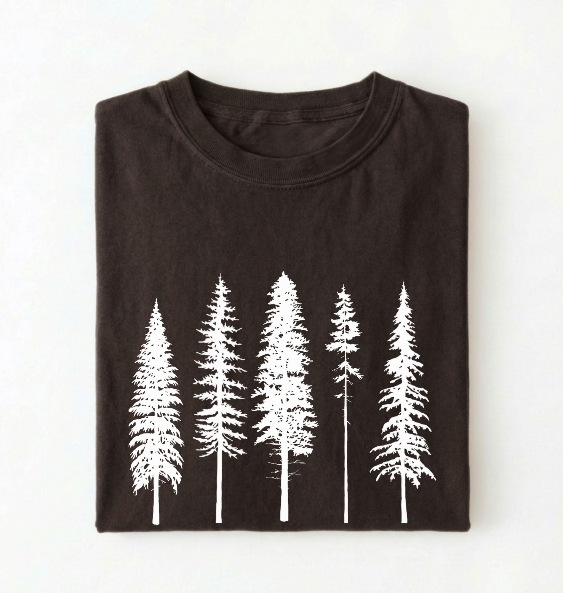 Flat lay of an Espresso t-shirt with white pine tree forest graphic, minimalist nature design for hiking and outdoor lovers on a white background 