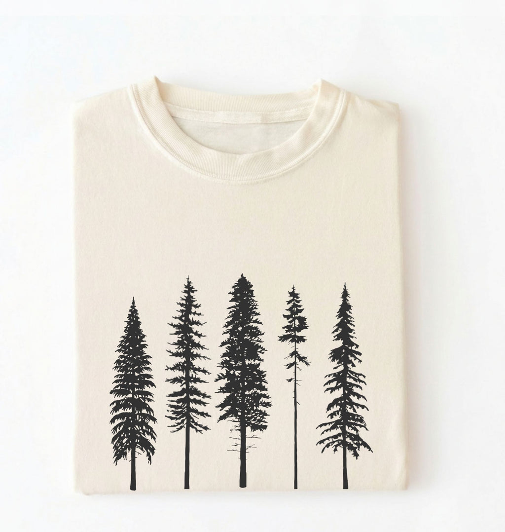 Flat lay of an ivory t-shirt with white pine tree forest graphic, minimalist nature design for hiking and outdoor lovers on a white background