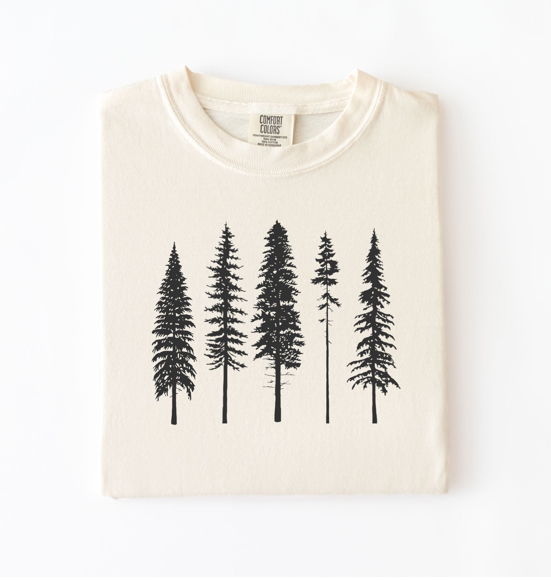 Ivory t-shirt with black pine tree forest graphic, minimalist nature design for hiking and outdoor lovers