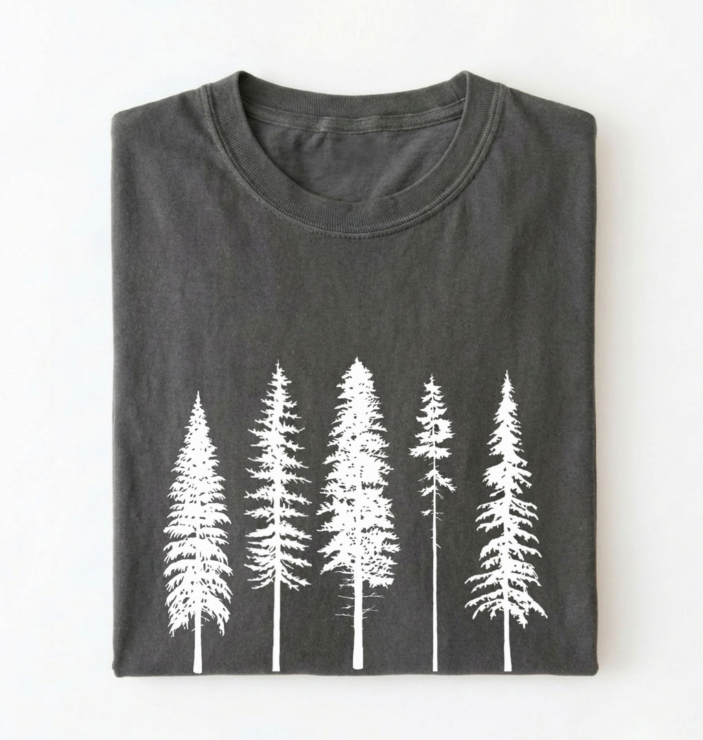 Flat lay of an pepper t-shirt with white pine tree forest graphic, minimalist nature design for hiking and outdoor lovers on a white background