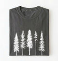 Flat lay of an pepper t-shirt with white pine tree forest graphic, minimalist nature design for hiking and outdoor lovers on a white background
