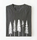 Flat lay of an pepper t-shirt with white pine tree forest graphic, minimalist nature design for hiking and outdoor lovers on a white background