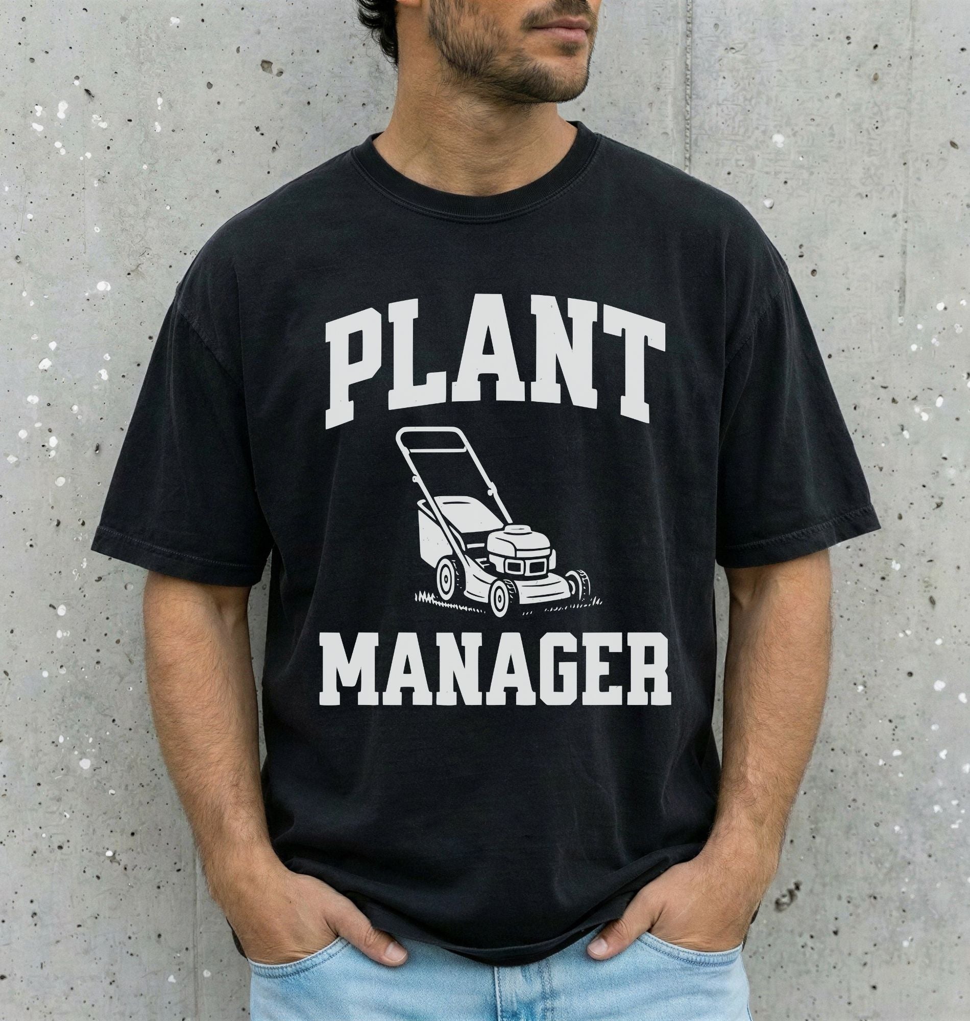 man wearing a black shirt that says "plant manager" with a lawn mower icon