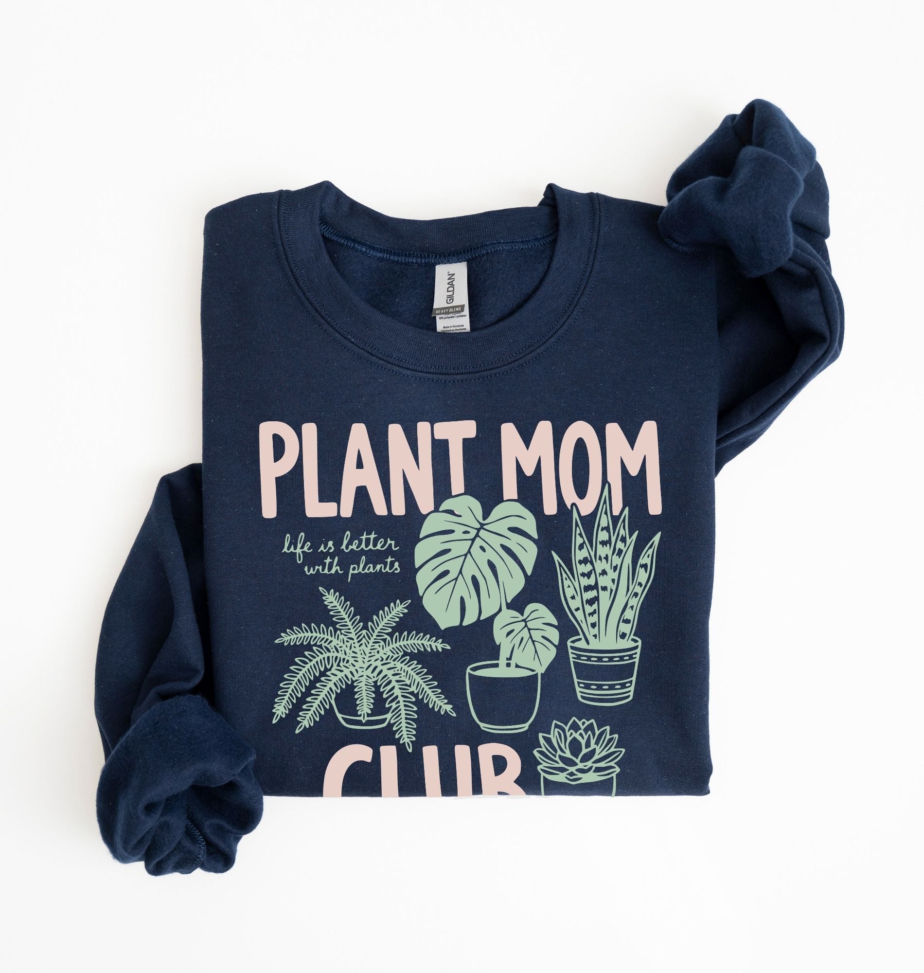 Flat lay of a forest green Plant mom club sweatshirt with houseplant illustrations perfect gift for plant lovers and indoor plant enthusiasts on a white background