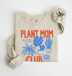Flat lay of a sand Plant mom club sweatshirt with houseplant illustrations perfect gift for plant lovers and indoor plant enthusiasts on a white background