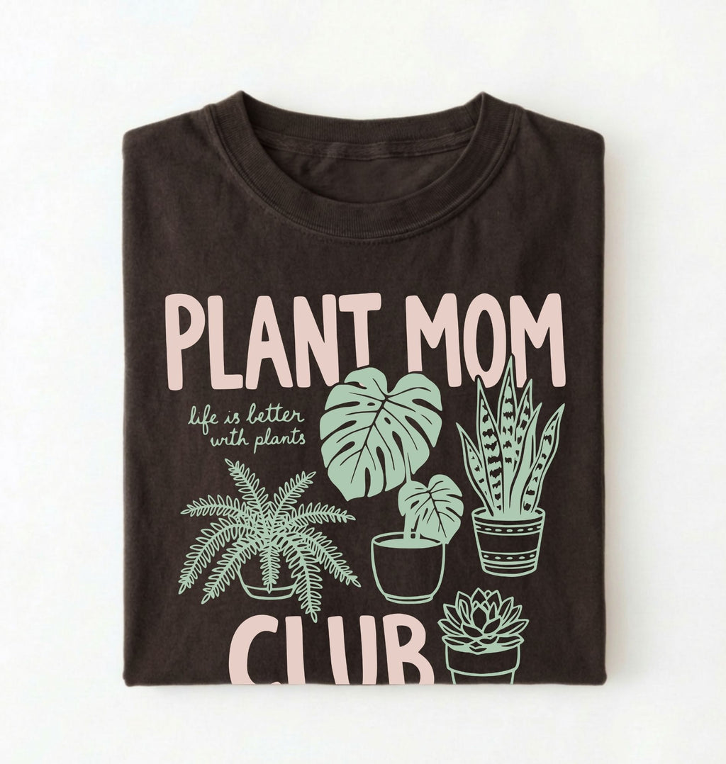 flat lay Plant Mom Club t-shirt with illustrated houseplants, perfect plant lover and gardener gift on a white background
