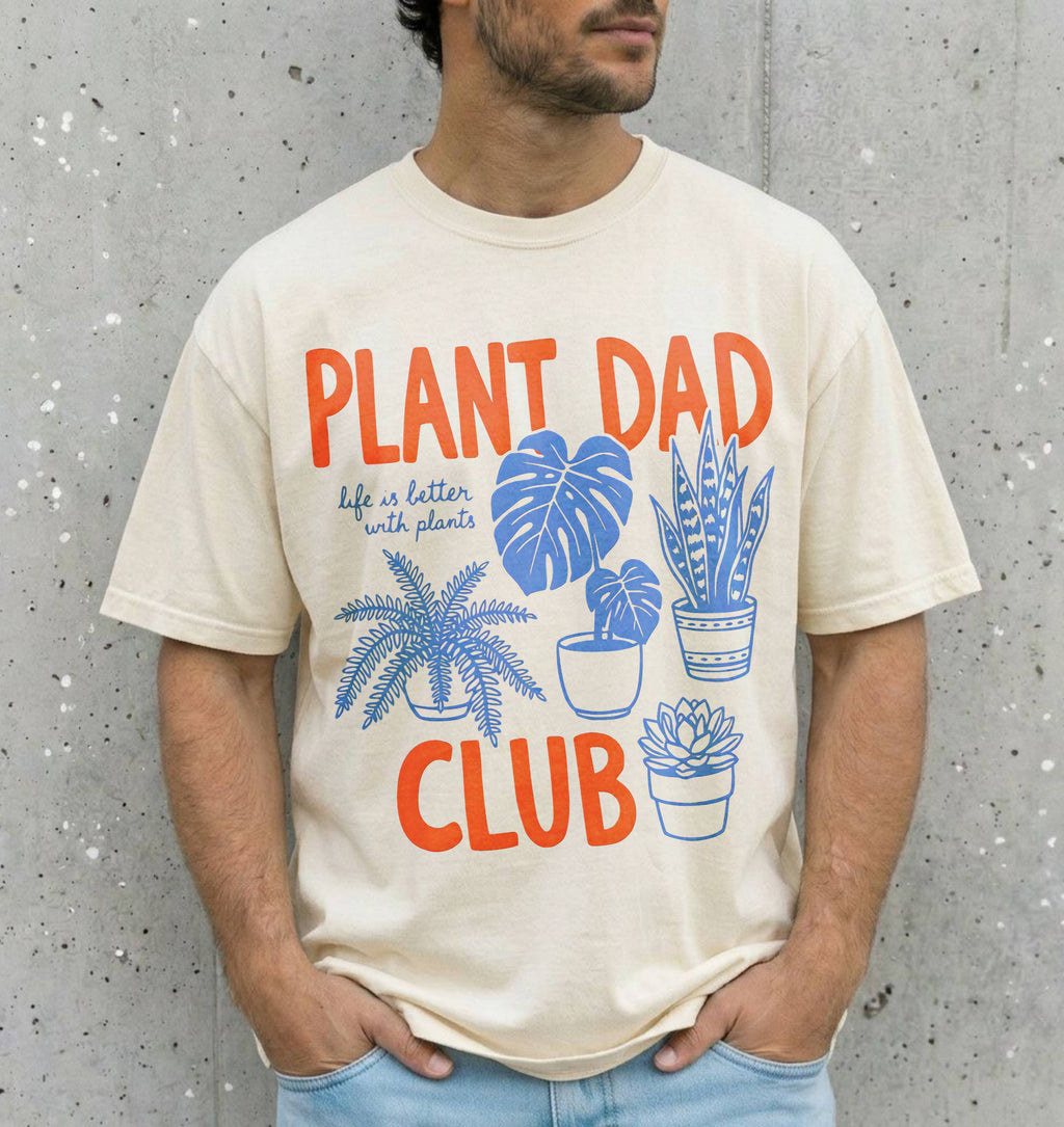 man wearing a natural colored shirt that says "plant dad club"