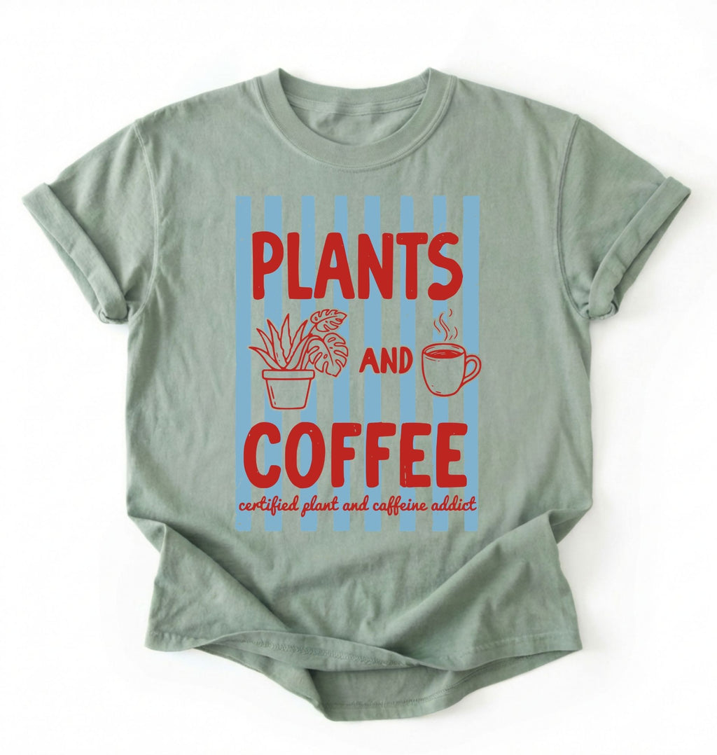 Flat lay of a Bay_Sage t-shirt featuring plant illustrations and a coffee cup with text reading “Plants and Coffee.” with retro stripes plant lover gift white graphic tee for coffee drinker and houseplant enthusiast on a white background 