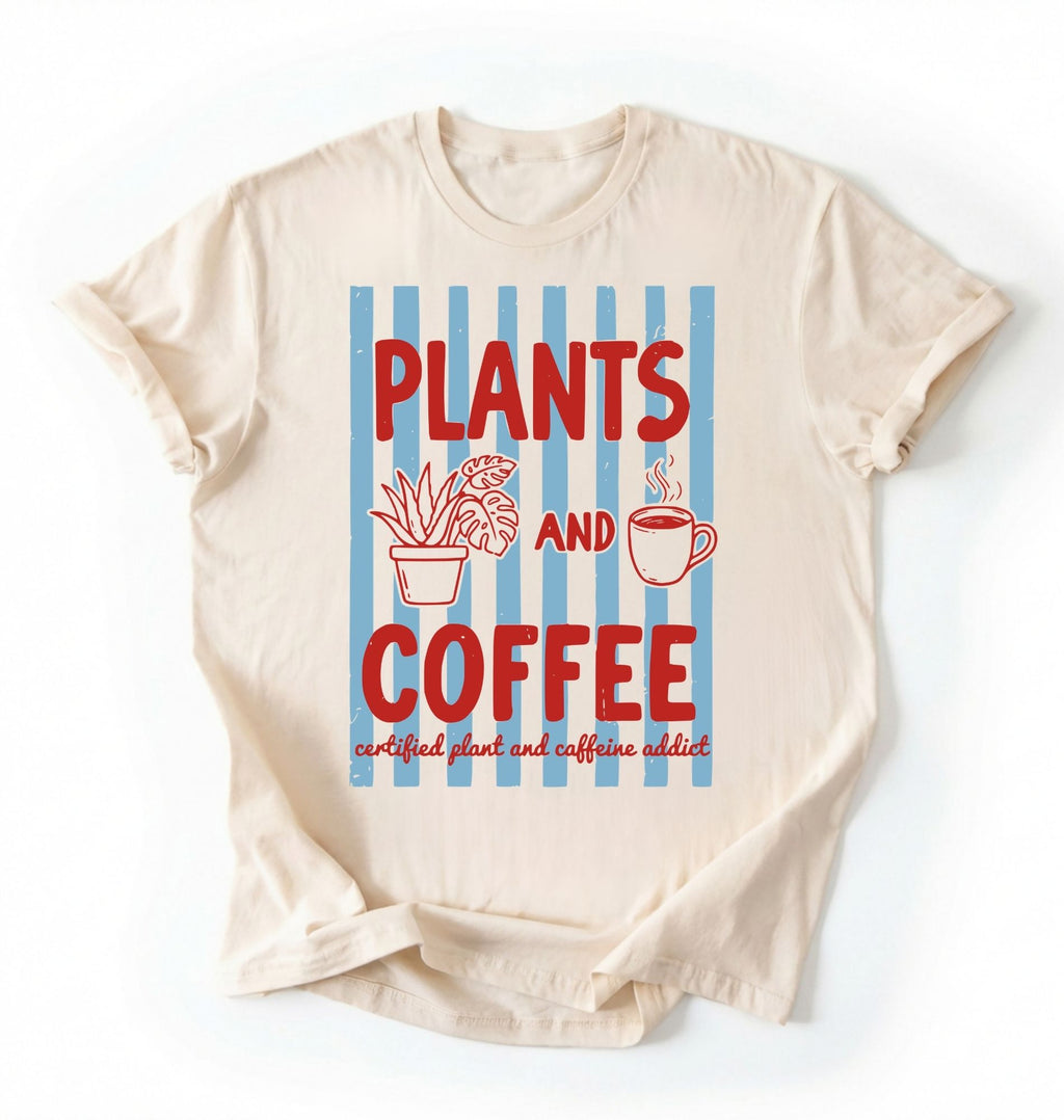 Flat lay of a Natural ivory t-shirt featuring plant illustrations and a coffee cup with text reading “Plants and Coffee.” with retro stripes plant lover gift white graphic tee for coffee drinker and houseplant enthusiast on a white background 