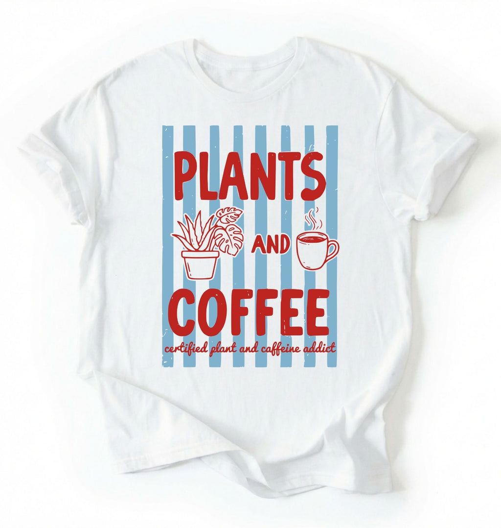 Flat lay of a white t-shirt featuring plant illustrations and a coffee cup with text reading “Plants and Coffee.” with retro stripes plant lover gift white graphic tee for coffee drinker and houseplant enthusiast on a white background 
