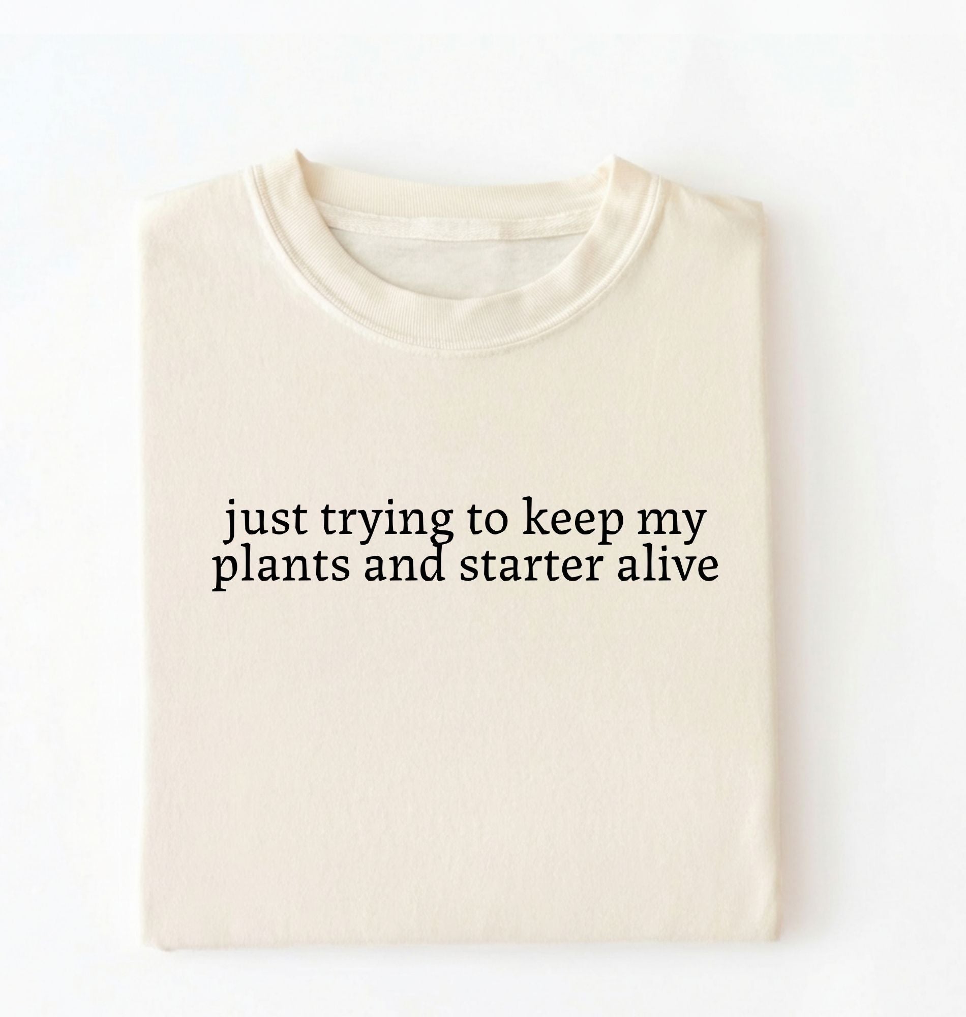 Flat lay of an ivory plants and sourdough starter shirt white funny minimalist plant lover baking t shirt gift on a whiter 