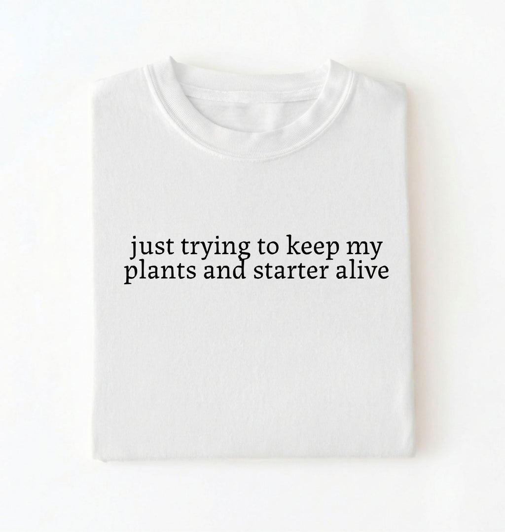 Flat lay of a white plants and sourdough starter shirt white funny minimalist plant lover baking t shirt gift on a whiter 