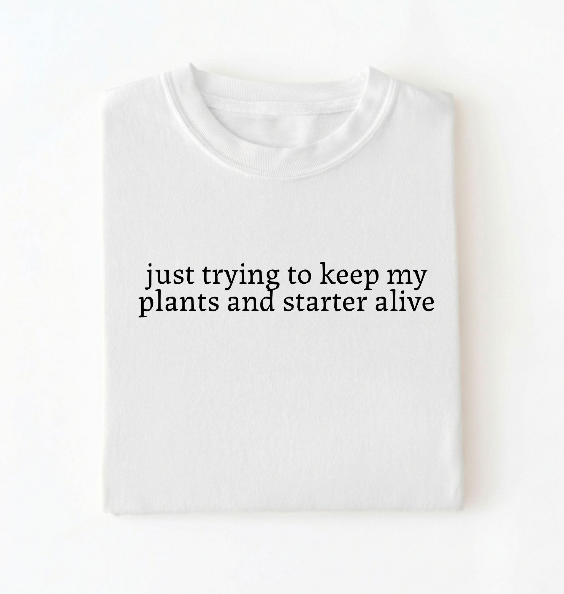 Flat lay of a white plants and sourdough starter shirt white funny minimalist plant lover baking t shirt gift on a whiter 