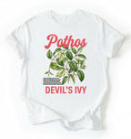 Flat lay of a white t-shirt featuring a botanical leaf illustration of Pothos leaves with text reading “Pothos Devil’s Ivy” perfect gift for plant lovers and houseplant enthusiasts on white background 