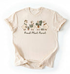 Flat lay natural t-shirt with text reading 'Proud Plant Parent' featuring illustrated ducks on a white background