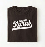 Flat lay of a Raise Them dark chocolate country graphic shirt on pepper tee for farm families and rural lifestyle lovers on a white background 