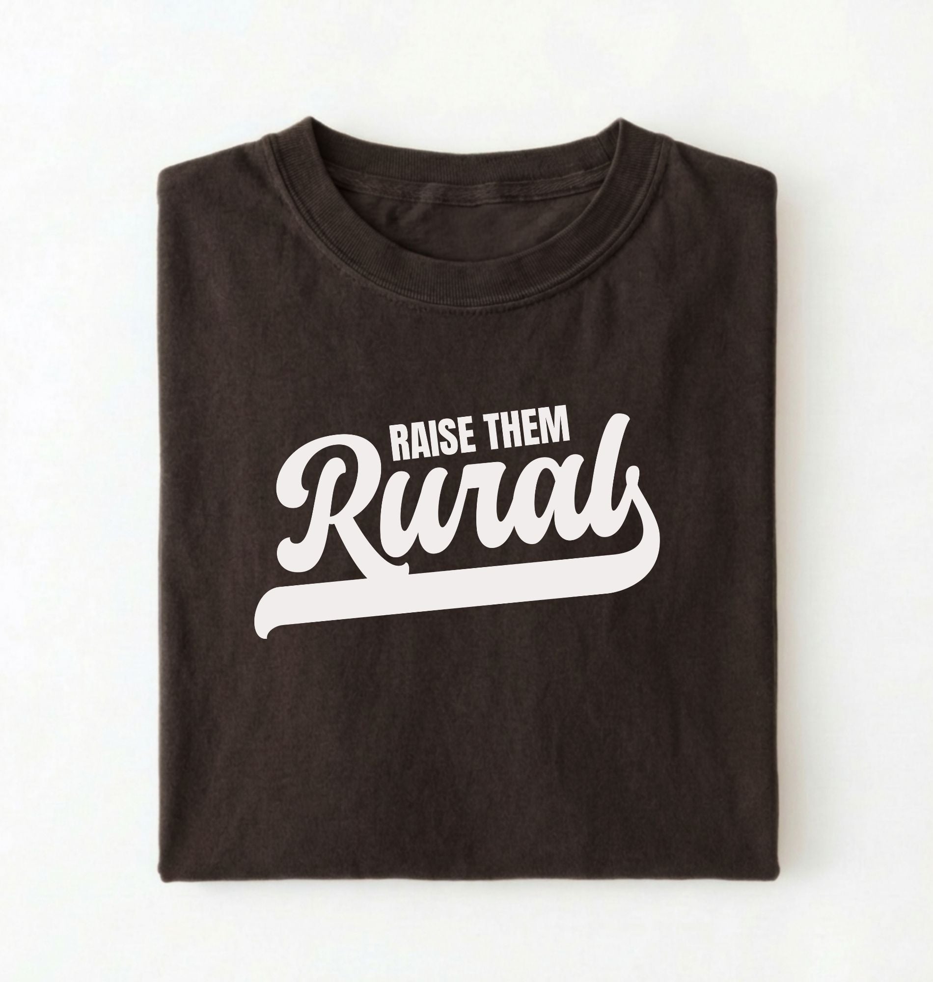 Flat lay of a Raise Them dark chocolate country graphic shirt on pepper tee for farm families and rural lifestyle lovers on a white background 