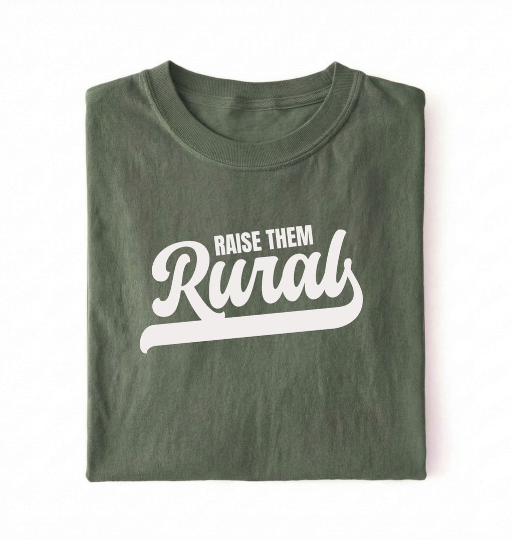 Flat lay of a Raise Them green country graphic shirt on pepper tee for farm families and rural lifestyle lovers on a white background 