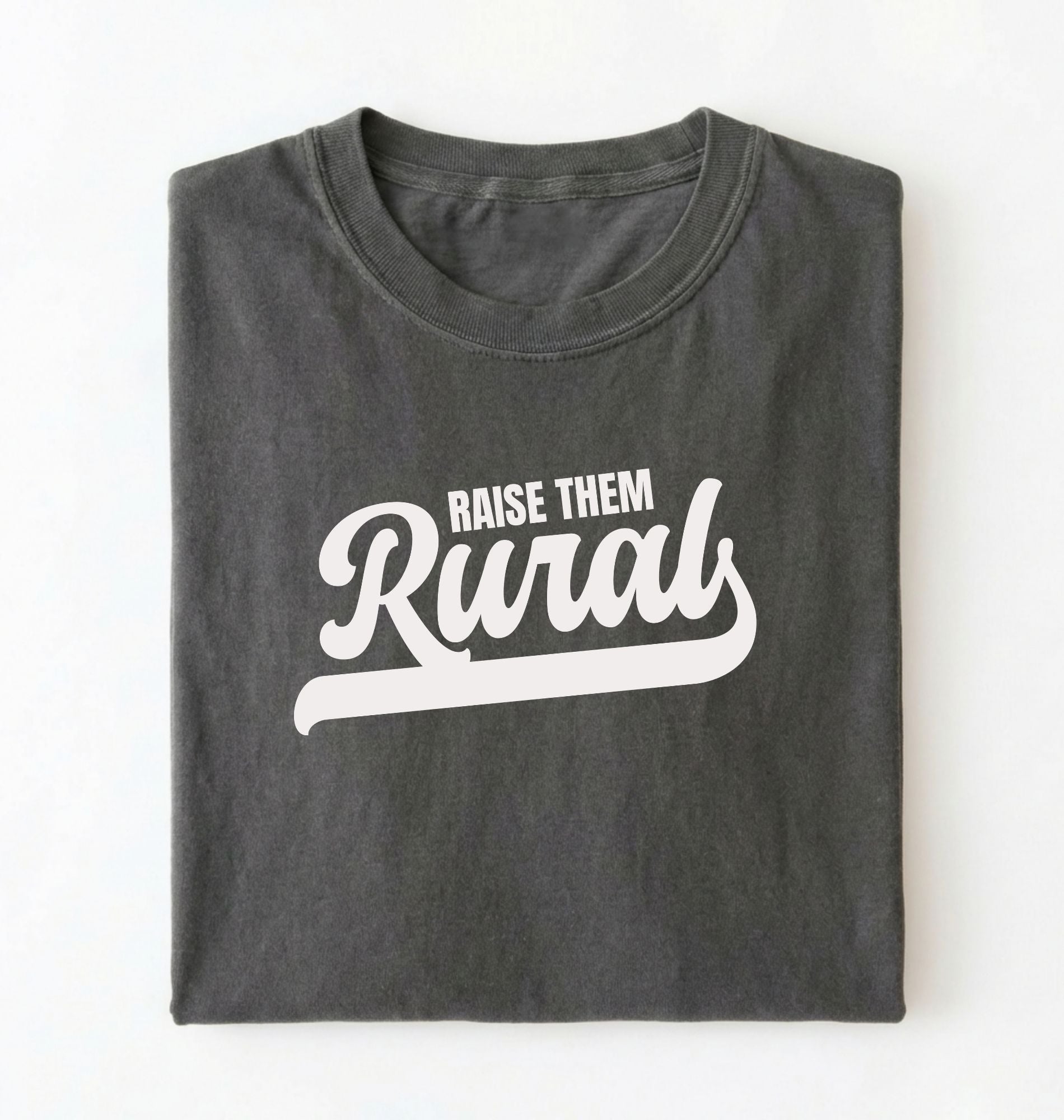 Flat lay of a Raise Them Rural country graphic shirt on pepper tee for farm families and rural lifestyle lovers on a white background 