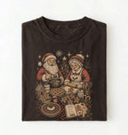Dark chocolate Christmas baking shirt featuring Santa and Mrs Claus making gingerbread cookies and pies with festive kitchen supplies