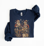 A navy blue long-sleeve sweatshirt with a vintage Christmas graphic of Santa Claus and Mrs. Claus baking cookies, styled flat on a white background.