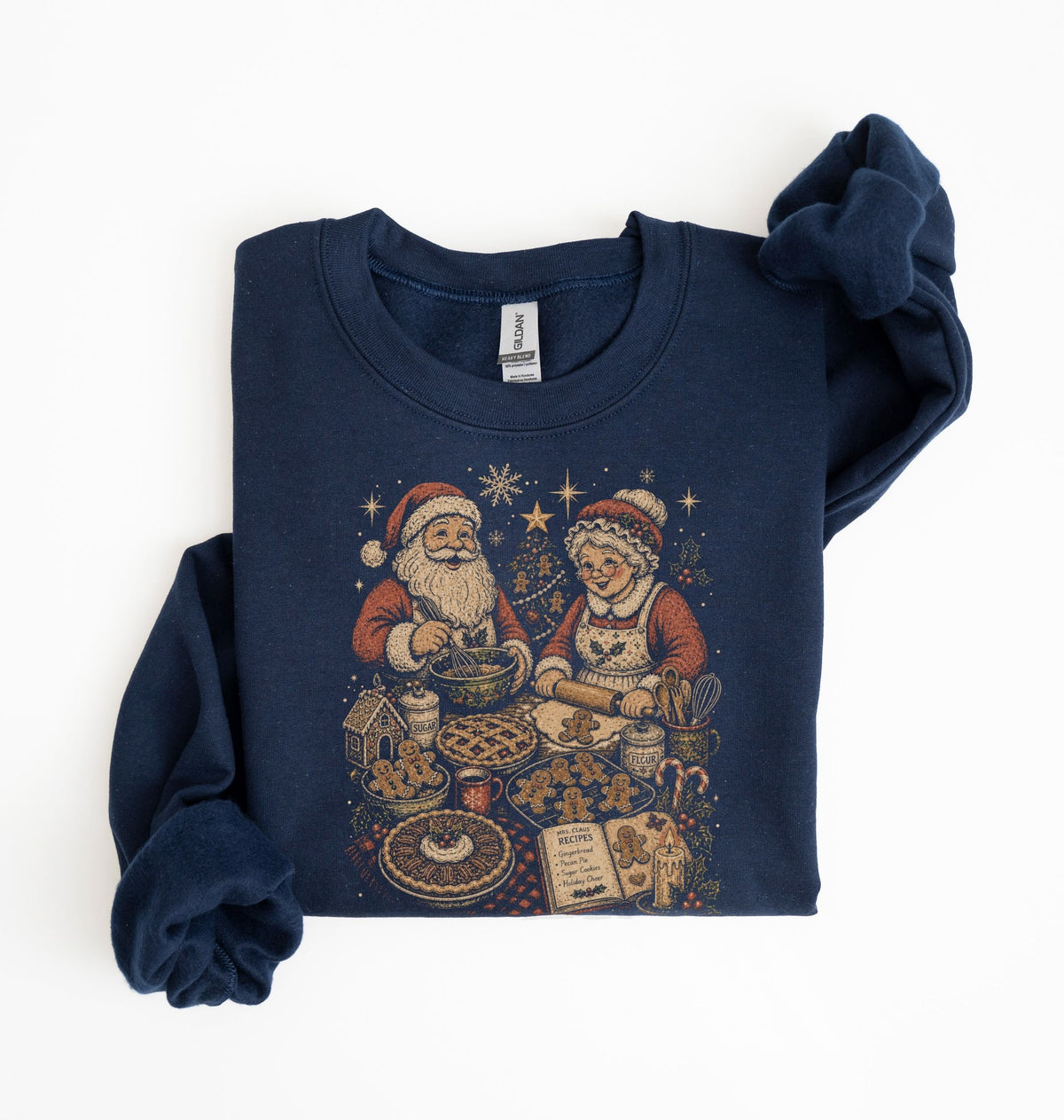 A navy blue long-sleeve sweatshirt with a vintage Christmas graphic of Santa Claus and Mrs. Claus baking cookies, styled flat on a white background.
