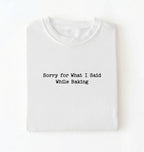A folded white t-shirt with the black printed text 'Sorry for What I Said While Baking' centered on the chest, presented on a clean white background.