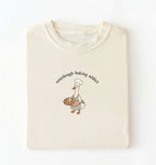 Flat lay of a ivory Sourdough Baking Addict shirt with baker goose holding artisan bread for sourdough enthusiasts on a white background 