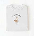 Flat lay of a white Sourdough Baking Addict shirt with baker goose holding artisan bread for sourdough enthusiasts on a white background 