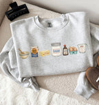Gray sweatshirt with food-themed illustrations on a textured surface