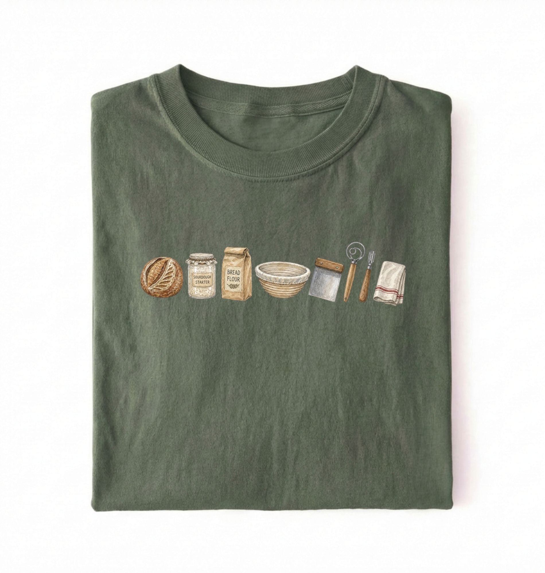 Flat lay of a green sourdough baking essentials shirt with starter flour dough bowl and bread making tools on a white background 