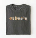 Flat lay of a charcoal sourdough baking essentials shirt with starter flour dough bowl and bread making tools on a white background 