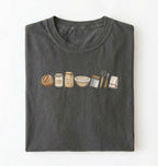 Flat lay of a charcoal sourdough baking essentials shirt with starter flour dough bowl and bread making tools on a white background 