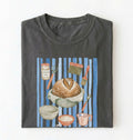 Flat lay of a charcoal Sourdough baking tools shirt featuring artisan bread, starter jar, banneton, and baking supplies on a white background 