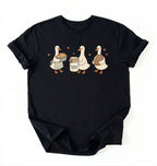 Flat lay of a black Cute sourdough ducks graphic shirt featuring bread and sourdough starter design for bakers on a white background