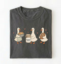 Flat lay of a gray Cute sourdough ducks graphic shirt featuring bread and sourdough starter design for bakers on a white background