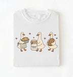 Flat lay of a white Cute sourdough ducks graphic shirt featuring bread and sourdough starter design for bakers on a white background