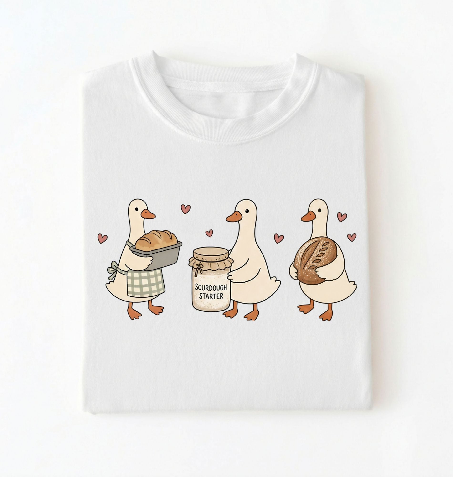 Flat lay of a white Cute sourdough ducks graphic shirt featuring bread and sourdough starter design for bakers on a white background
