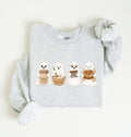 Flat lay of an ash sourdough sweatshirt featuring four cute baking ghosts with a starter jar, mixing bowl, bench scraper and bread loaf on a white background 