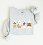 Flat lay of an ash sourdough sweatshirt featuring four cute baking ghosts with a starter jar, mixing bowl, bench scraper and bread loaf on a white background 