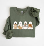 Flat lay of a green sourdough sweatshirt featuring four cute baking ghosts with a starter jar, mixing bowl, bench scraper and bread loaf on a white background 