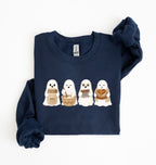Flat lay of a navy sourdough sweatshirt featuring four cute baking ghosts with a starter jar, mixing bowl, bench scraper and bread loaf on a white background 