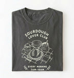 Flat lay of a gray Sourdough Lover Club graphic shirt with artisan bread baking design for sourdough enthusiasts on a white background 