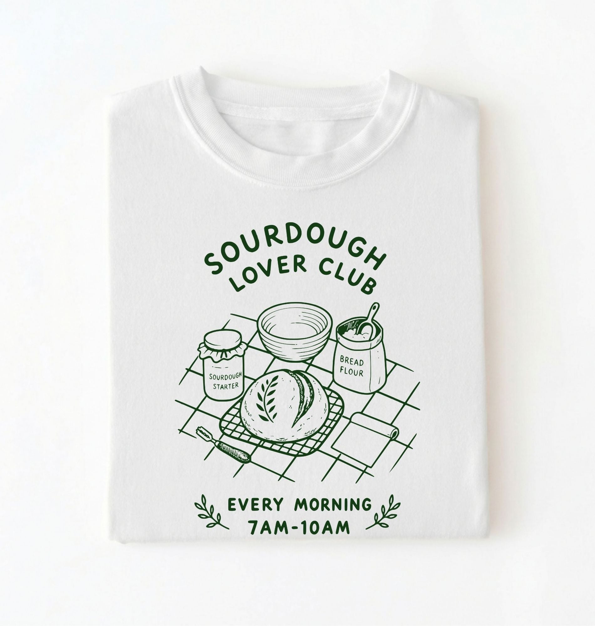 Flat lay of a white Sourdough Lover Club graphic shirt with artisan bread baking design for sourdough enthusiasts on a white background 