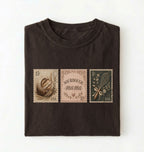 Flat lay of a dark chocolate sourdough mama shirt brown vintage baking stamps t shirt bread lover gift cozy kitchen design on a white background
