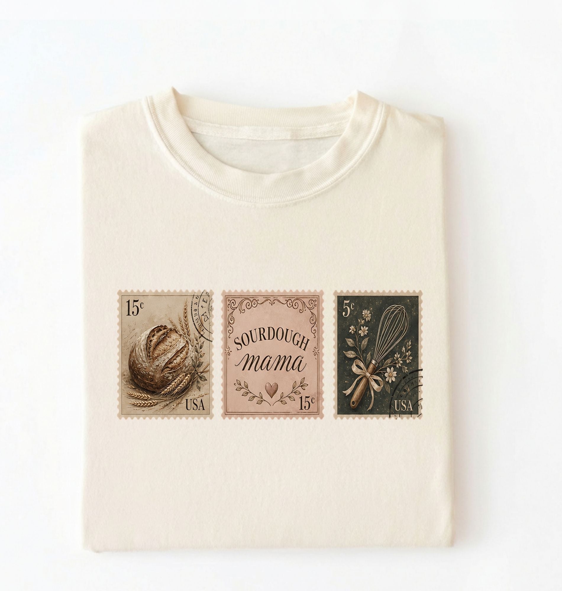 Flat lay of a cream sourdough mama shirt brown vintage baking stamps t shirt bread lover gift cozy kitchen design on a white background