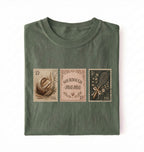 Flat lay of a moss sourdough mama shirt brown vintage baking stamps t shirt bread lover gift cozy kitchen design on a white background