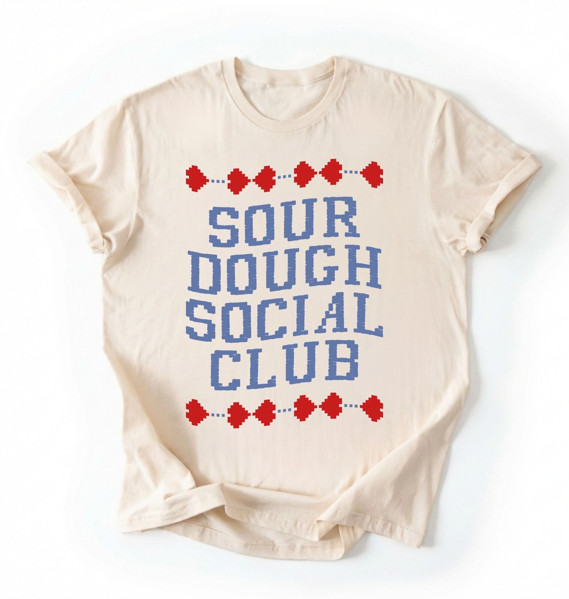 Flat lay of an ivory sourdough social club shirt cream funny baking t shirt bread lover gift cottagecore aesthetic on a white background 