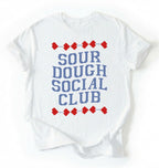 Flat lay of a white sourdough social club shirt cream funny baking t shirt bread lover gift cottagecore aesthetic on a white background 