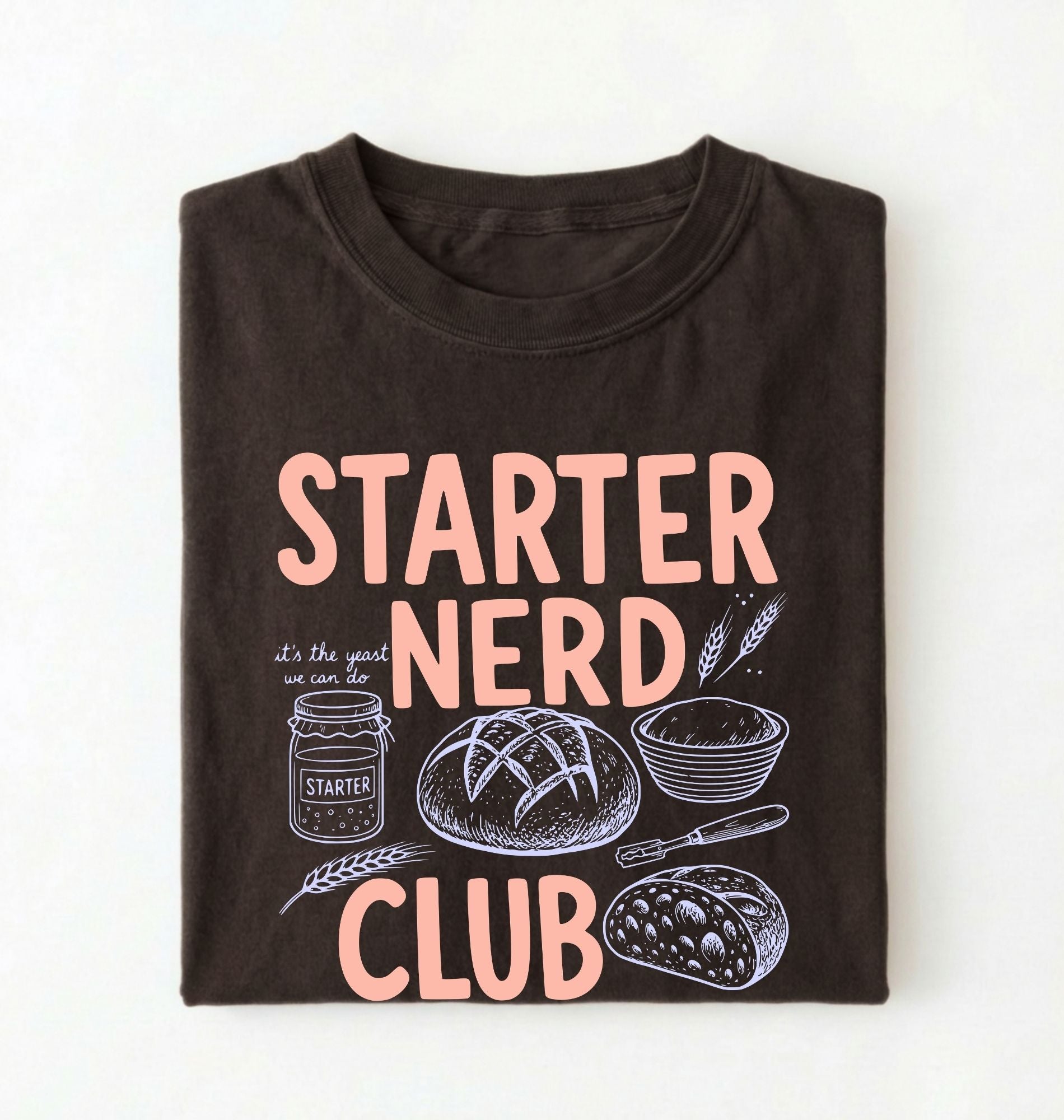 Flat lay of a brown starter nerd club shirt with sourdough starter jar bread and baking illustrations funny baker gift on a white background 